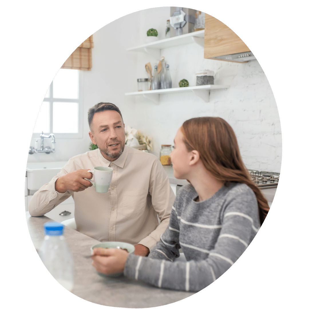 Dad and daughter talking in kitchen