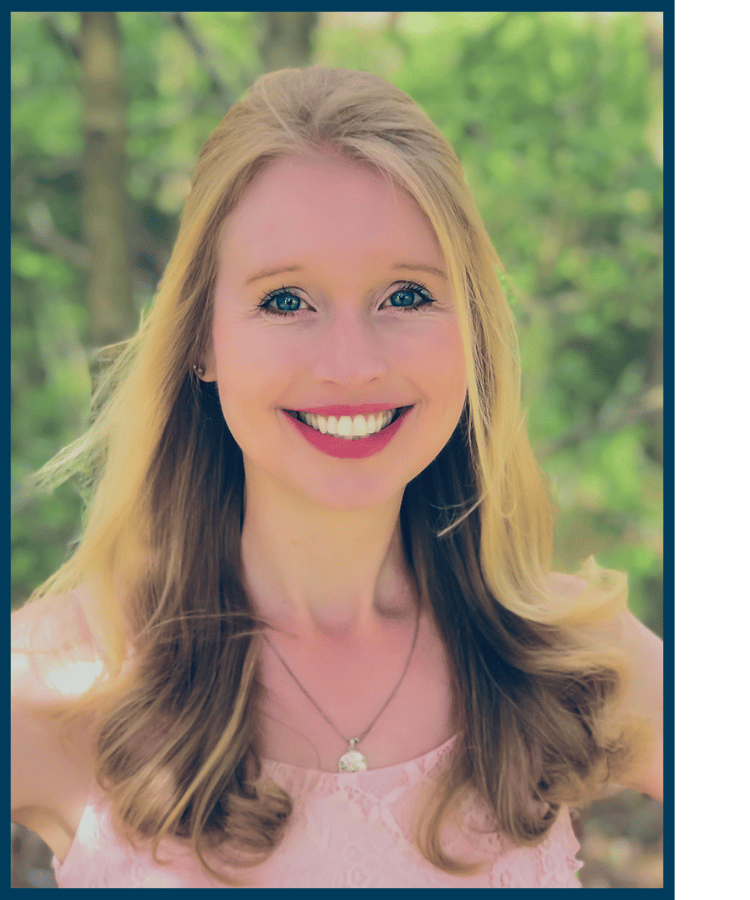 Blonde woman smiling in front of green, outdoors background